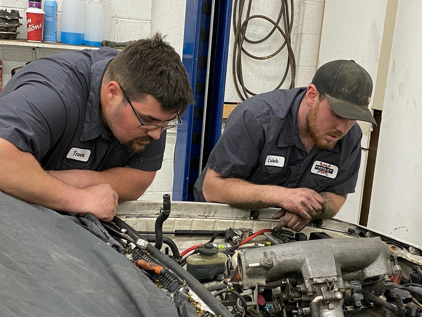 Travis Nagle, owner and lead mechanic of Chesley Service Centre, working on an engine.